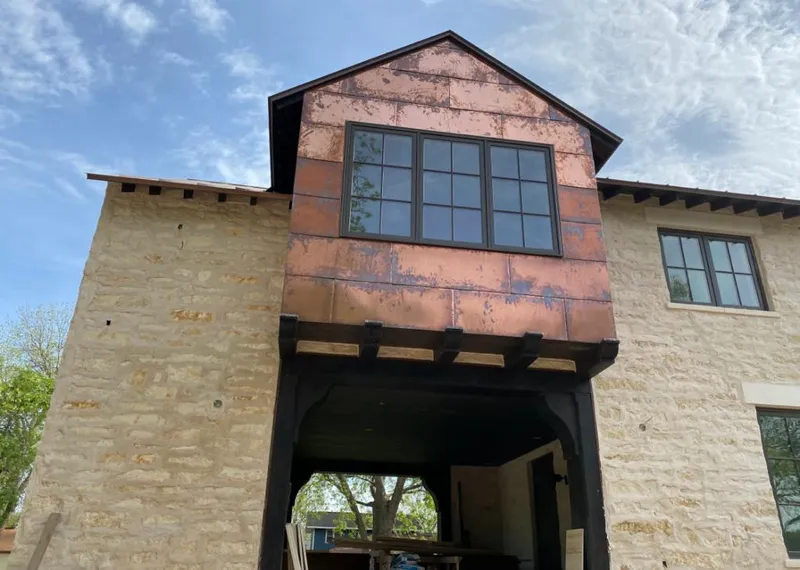 Copper metal panel facade on a stone building for Skylight Installation in Old Lyme